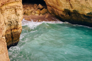 .Rock by the sea. the concept of harmony, energy of life and meditation. benagil in portugal, cliffs on the famous beach , waves crashing on cliffs, the raging ocean.
