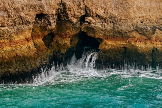 .Rock by the sea. the concept of harmony, energy of life and meditation. benagil in portugal, cliffs on the famous beach , waves crashing on cliffs, the raging ocean.