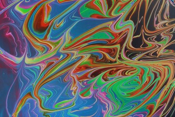Obraz premium Abstract multicolored marble background. Acrylic paint mixes freely and creates an interesting pattern. Bright saturated shades. Background for the cover of a laptop, laptop.