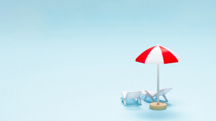 Travel concept. Sun lounger, red umbrella on a blue background.