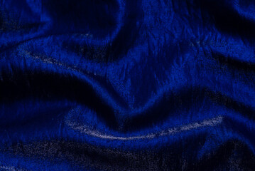 Purple shiny fabric as background. Top view.