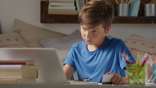 online shopping with credit card, student boy uses a computer at home, browses the internet looking for a purchase but is sad because he does not have enough credit card money, has to give up the game