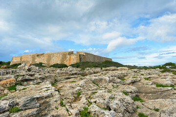 Fototapeta na wymiar old coast fortress under cloudy blue sky