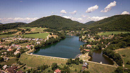 Fototapeta premium Aerial view of a lake in the village of Bansky Studenec in Slovakia
