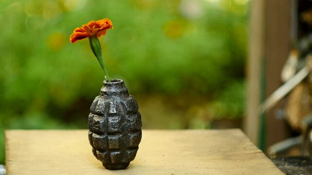flower and army hand grenade 