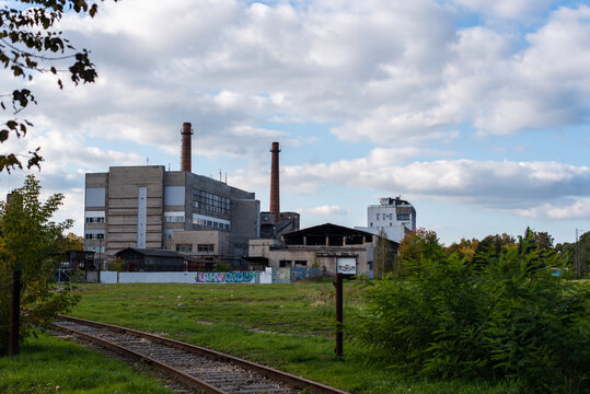 industrial plant and chimney with blue sky and clouds