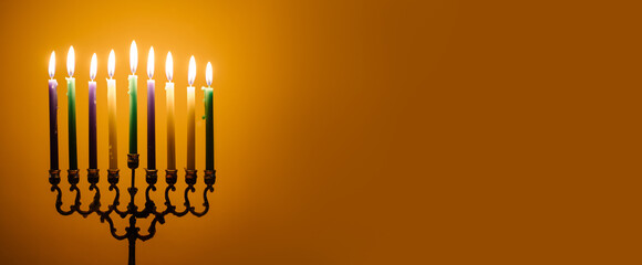 lights the menorah for Hanukkah.  Jewish holiday. Tradition is a religious ritual. Sunset. The...