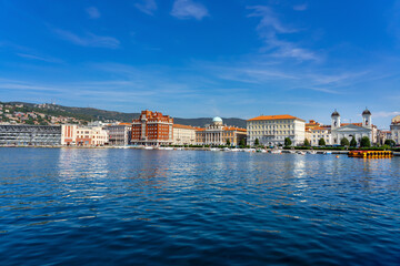 view of the city from molo audace pier in Trieste with beautiful buildings cityscape skyline shore