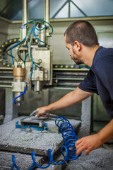 Engineer worker technician operating with CNC milling metal engraving machine