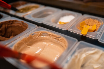 A photo of delicious cream chocolates in a modern patisserie. Selective focus