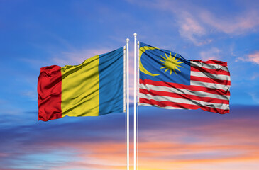 Romania and Malaysia two flags on flagpoles and blue sky