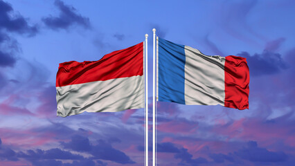 France and Indonesia two flags on flagpoles and blue cloudy sky