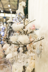 Close up of Christmas location with white fluffy toys on the branches