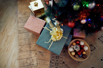 Wrapped gifts under Christmas tree at home.