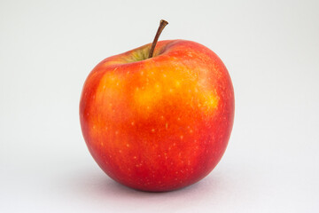 Red apple on a light gray background. Organic fruit, healthy eating, diet, lifestyle concept, treatment choice concept. Non - GMO. High-quality photo