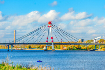 The first cable-stayed bridge in Russia across the Sheksna River in Cherepovets. City landscape on a sunny day.