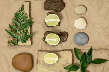 Creative layout of geometry from nature of materials, craft paper, wood, stone with fern leaves. Flat lay. A place for any products.