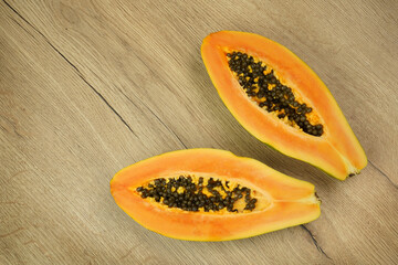  Tropical fruit papaya .   On wooden background.
