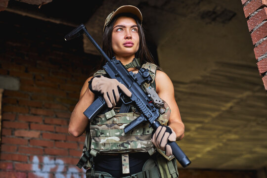 Woman British Special Forces Soldier With Weapon Take Part In Military Maneuver. War, Army, Technology And People Concept. Lady In Military Gear In Abandoned Building Alone, In Position, Look At Side