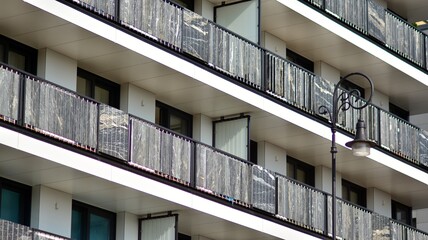 Fototapeta premium Modern apartment building. Modern urban architecture and details of building facade. Sunlight.