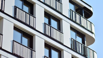 Modern apartment building. Modern urban architecture and details of building facade. Sunlight.