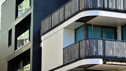 Modern apartment building. Modern urban architecture and details of building facade. Sunlight.