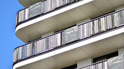 Modern apartment building. Modern urban architecture and details of building facade. Sunlight.