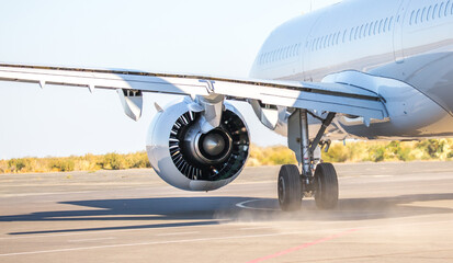 The plane is preparing to fly at the airport. Airplane on the runway at the airport. The turbine of...