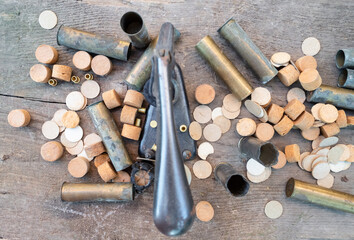 cases, wads, primers and reloading press on plank