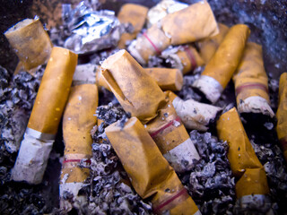 A number of cigarette butts in the ashtray