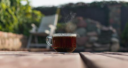 A cup of hot tea on the plank floor