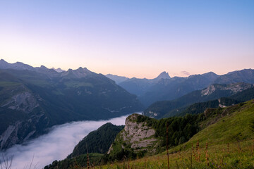 amazing sunrise in the ossau valley. magnificent sea of clouds in the valley. pic du midi d'ossau in the background. portrait format shot