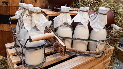 fresh organic milk from a farmer in glass bottles is in wooden boxes. rustic country products