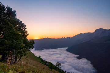 amazing sunrise in the ossau valley. magnificent sea of clouds in the valley.  panoramic format shot