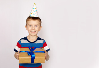 Portrait of happy cute kid holding gift box. holiday concept