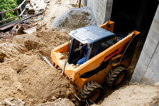 Moving soil with a skid-steer loader