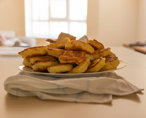 Freshly baked pancakes in a white plate on the table. Delicious morning breakfast with hot pancakes. homemade delicious fried
