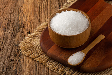 Fototapeta na wymiar Coarse salt in bowl on wooden background.