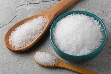 Bowl with coarse salt on the table.