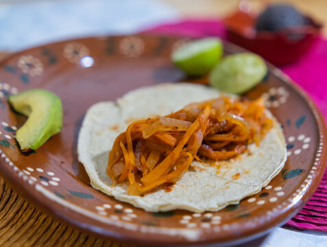 Vegan Mexican tinga taco on traditional clay plate