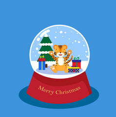 Happy tiger cub in a snowy glass ball with spruce