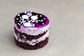 chocolate cake with cream covered with blueberry jam