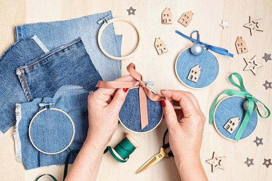 Diy project of christmas ornaments made of re-purposed old jeans and embroidery hoops. Easy handmade xmas decoration, gift idea. Upcycling concept. Flat lay, top view