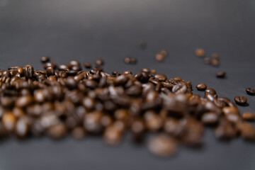 Pile of roasted coffee beans with dark gray background