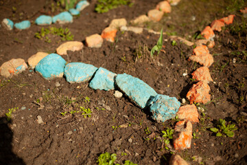 Stones in the garden. Ornament of small stones on the ground.