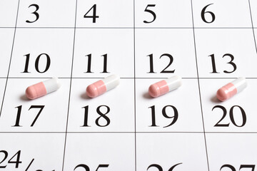 Medicines. A close-up of pink capsules with pills is in the calendar.