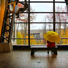 A person looks out on the Kinzua Viaduct Skywalk from inside visitors center.