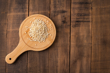 White organic quinoa seeds on the wooden board - Chenopodium quinoa