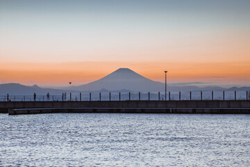 Obraz premium Mountain Fuji with skyline reflection and mist on water of lake Shoji Shojiko at sunrise, Yamanashi, Japan. Famous travel 5 lakes to see mount Fujisan.