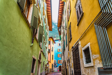 Narrow and colorful streets in a typical Italian village on the foothills of the mountains.